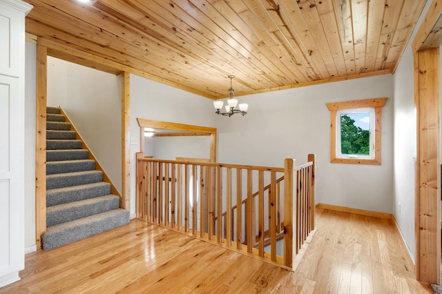2487 2nd St SW, Buffalo, MN 55313 - stairs featuring wood-type flooring, a chandelier, wooden ceiling, and baseboards