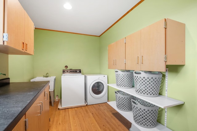 2487 2nd St SW, Buffalo, MN 55313 - laundry room featuring washer and dryer, cabinet space, light wood-type flooring, and ornamental molding