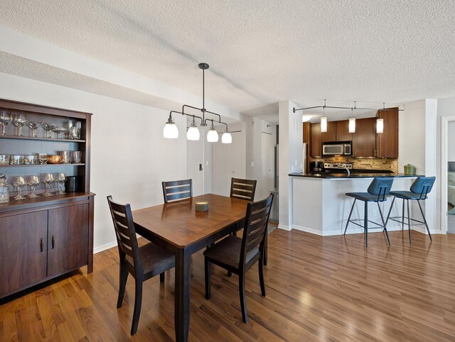 401 1st St Unit 601, Minneapolis, MN 55401 - dining space with a textured ceiling, wood finished floors, and track lighting