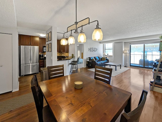 401 1st St Unit 601, Minneapolis, MN 55401 - dining area with a textured ceiling and wood finished floors