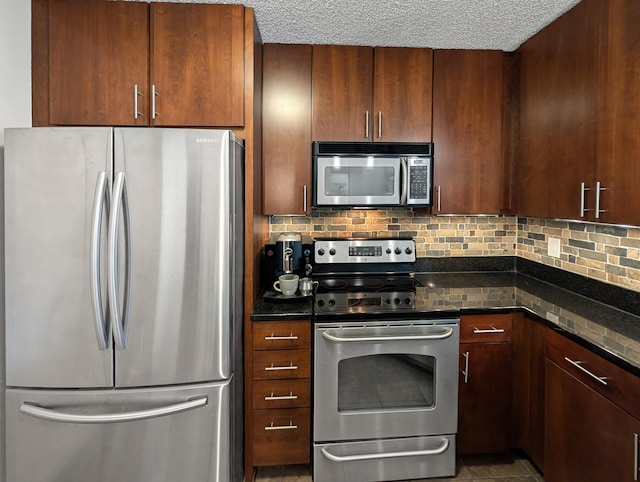 401 1st St Unit 601, Minneapolis, MN 55401 - kitchen featuring appliances with stainless steel finishes, decorative backsplash, dark stone counters, and a textured ceiling