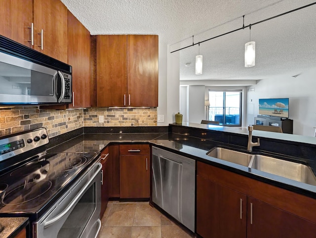 401 1st St Unit 601, Minneapolis, MN 55401 - kitchen with stainless steel appliances, a textured ceiling, a sink, decorative backsplash, and decorative light fixtures
