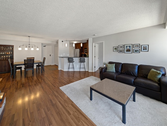 401 1st St Unit 601, Minneapolis, MN 55401 - living room featuring a textured ceiling, wood finished floors, and a chandelier