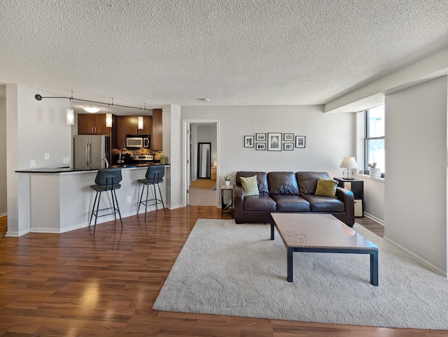 401 1st St Unit 601, Minneapolis, MN 55401 - living room featuring a textured ceiling, wood finished floors, and baseboards