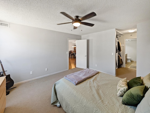 401 1st St Unit 601, Minneapolis, MN 55401 - carpeted bedroom featuring a ceiling fan, baseboards, a textured ceiling, and connected bathroom