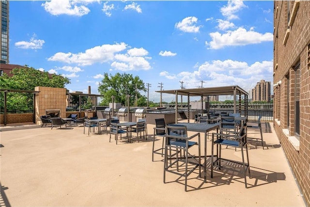 401 1st St Unit 601, Minneapolis, MN 55401 - view of patio featuring an outdoor fireplace and an outdoor kitchen