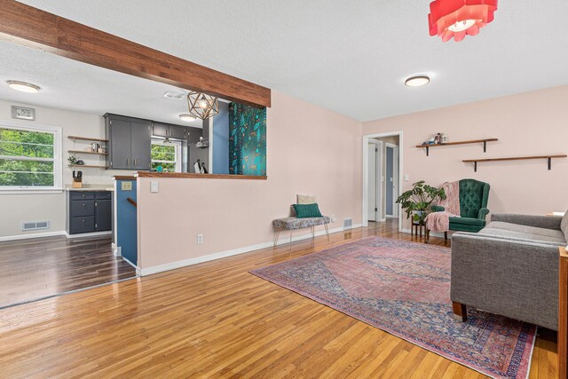7109 Douglas Dr N, Brooklyn Park, MN 55429 - living room featuring wood finished floors, baseboards, and a textured ceiling
