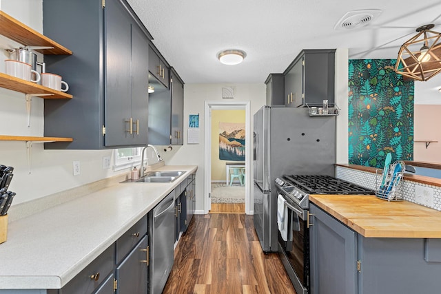 7109 Douglas Dr N, Brooklyn Park, MN 55429 - kitchen with a sink, stainless steel appliances, dark wood-type flooring, light countertops, and open shelves