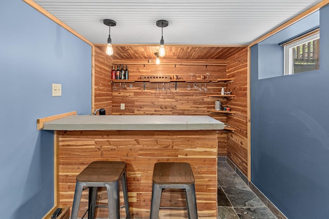 7109 Douglas Dr N, Brooklyn Park, MN 55429 - indoor dry bar with wood walls, dark stone finish floors, wood ceiling, decorative light fixtures, and baseboards