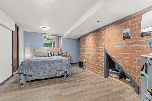 7109 Douglas Dr N, Brooklyn Park, MN 55429 - bedroom with light wood-type flooring and brick wall