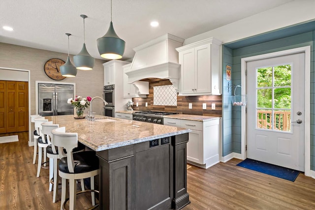 15084 Appaloosa Trl NE, Prior Lake, MN 55372 - kitchen featuring stainless steel appliances, white cabinetry, dark wood finished floors, light stone countertops, and recessed lighting