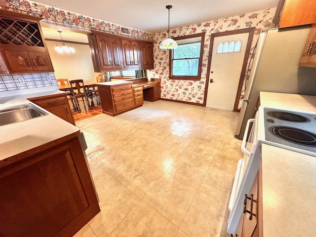 212 Carrow Cir, Marshall, MN 56258 - kitchen featuring wallpapered walls, electric stove, pendant lighting, light countertops, and baseboards