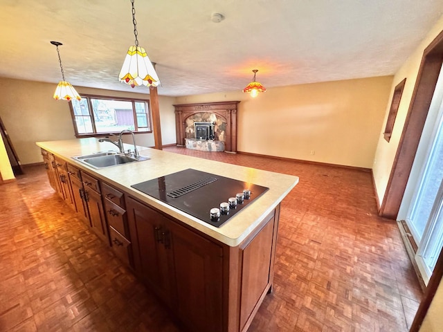 212 Carrow Cir, Marshall, MN 56258 - kitchen with a sink, black electric cooktop, light countertops, baseboards, and pendant lighting
