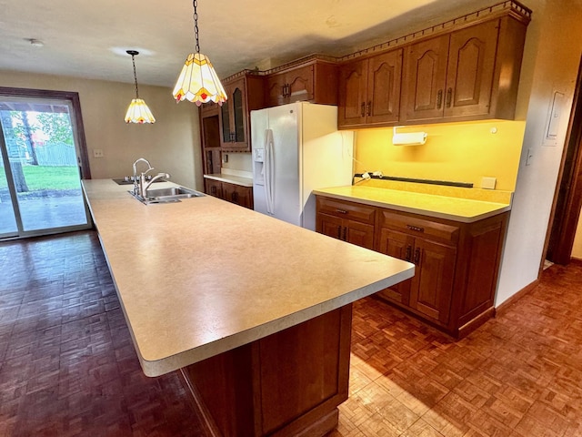 212 Carrow Cir, Marshall, MN 56258 - kitchen featuring white refrigerator with ice dispenser, a sink, light countertops, glass insert cabinets, and an island with sink