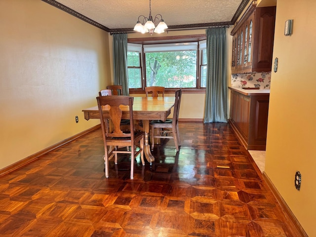 212 Carrow Cir, Marshall, MN 56258 - dining area with crown molding, a chandelier, a textured ceiling, and baseboards