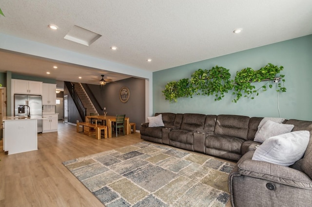 13323 Territorial Cir N, Maple Grove, MN 55369 - living room featuring stairs, light wood finished floors, and recessed lighting