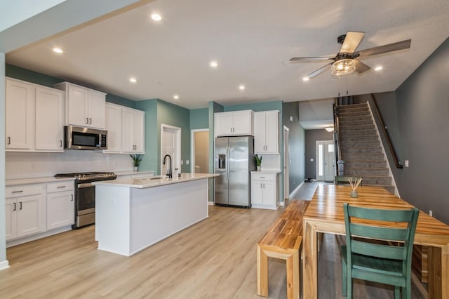 13323 Territorial Cir N, Maple Grove, MN 55369 - kitchen featuring appliances with stainless steel finishes, decorative backsplash, light countertops, a ceiling fan, and a sink