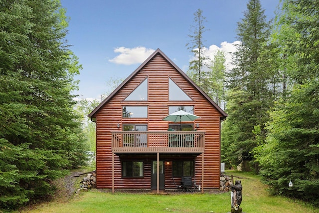 7194 Quentin Rd NE, Outing, MN 56662 - rear view of property featuring log veneer siding, a wooden deck, and a lawn