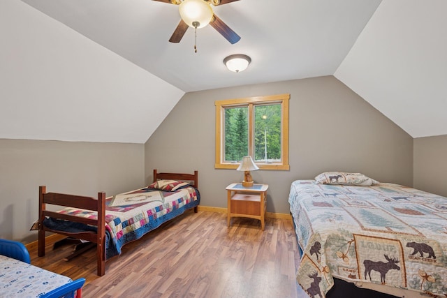 7194 Quentin Rd NE, Outing, MN 56662 - bedroom with wood finished floors, vaulted ceiling, baseboards, and ceiling fan