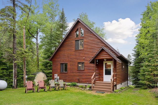 7194 Quentin Rd NE, Outing, MN 56662 - rear view of house featuring a lawn, faux log siding, and crawl space