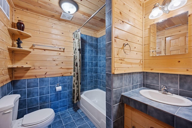 7194 Quentin Rd NE, Outing, MN 56662 - full bath featuring toilet, tile walls, tile patterned flooring, vanity, and shower / bath combo