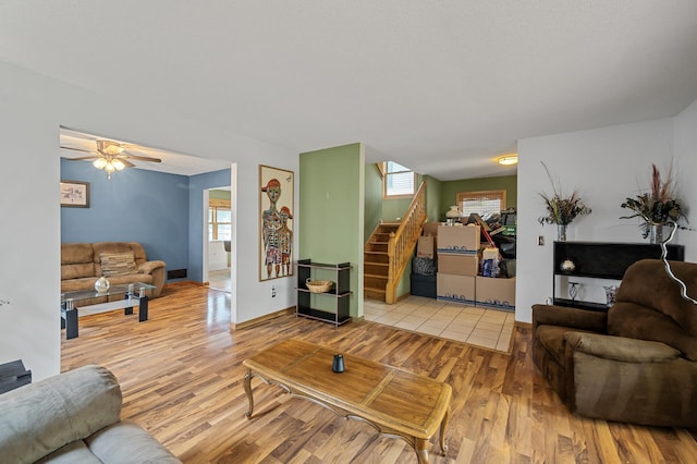 2651 Colfax Ave N, Minneapolis, MN 55411 - living area with stairway, light wood-style floors, and ceiling fan