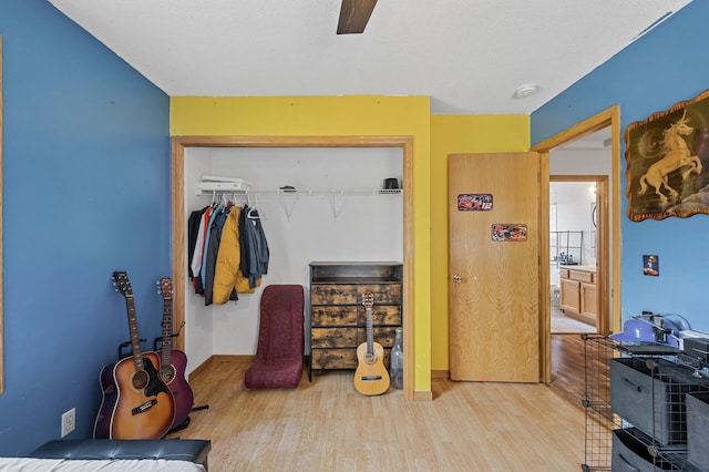 2651 Colfax Ave N, Minneapolis, MN 55411 - bedroom with a closet, wood finished floors, and a ceiling fan
