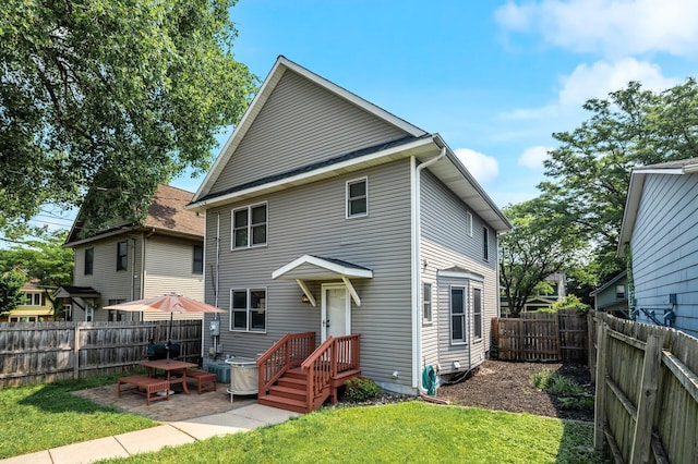 2651 Colfax Ave N, Minneapolis, MN 55411 - rear view of house featuring a fenced backyard and a patio area