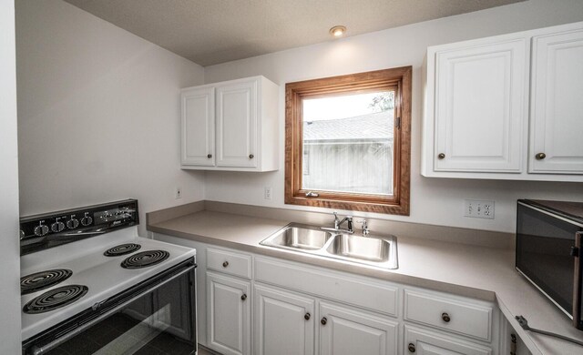 705 Grundhoefer Ct, Northfield, MN 55057 - kitchen featuring electric range oven, white cabinetry, and light countertops