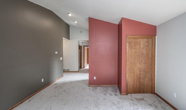 705 Grundhoefer Ct, Northfield, MN 55057 - unfurnished bedroom with vaulted ceiling and carpet flooring