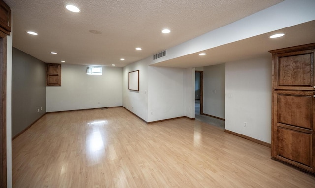 705 Grundhoefer Ct, Northfield, MN 55057 - basement featuring light wood-style floors, recessed lighting, and a textured ceiling