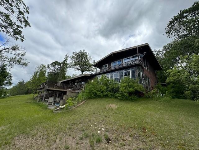 22560 Height Of Land Dr, Detroit Lakes, MN 56501 - rear view of property featuring a lawn and a wooden deck