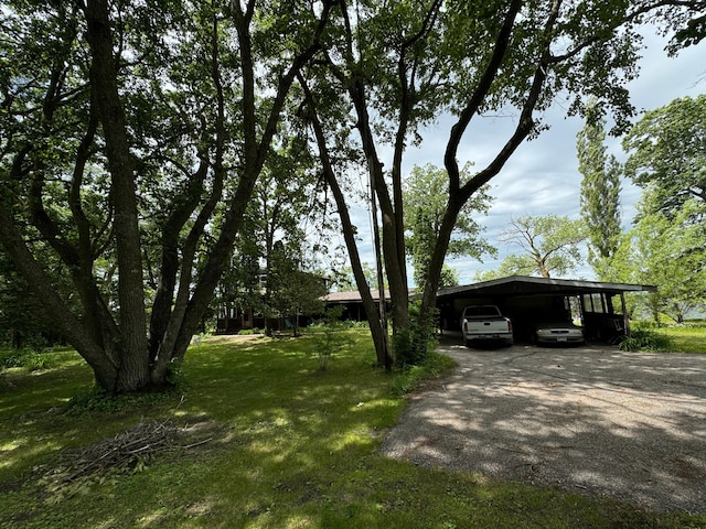 22560 Height Of Land Dr, Detroit Lakes, MN 56501 - view of green lawn with asphalt driveway and a detached carport