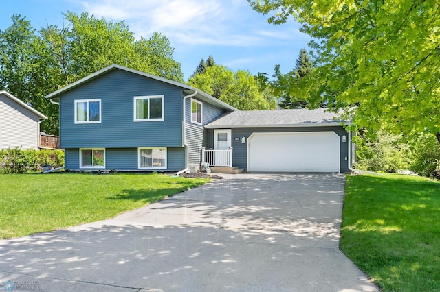 3003 15th Ave S, Moorhead, MN 56560 - split level home featuring a garage, concrete driveway, and a front lawn