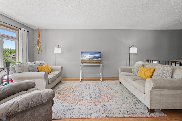 3003 15th Ave S, Moorhead, MN 56560 - living area with wood finished floors, a textured ceiling, and baseboards
