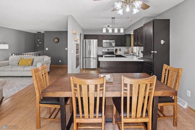 3003 15th Ave S, Moorhead, MN 56560 - dining space featuring light wood-style floors, ceiling fan, and baseboards