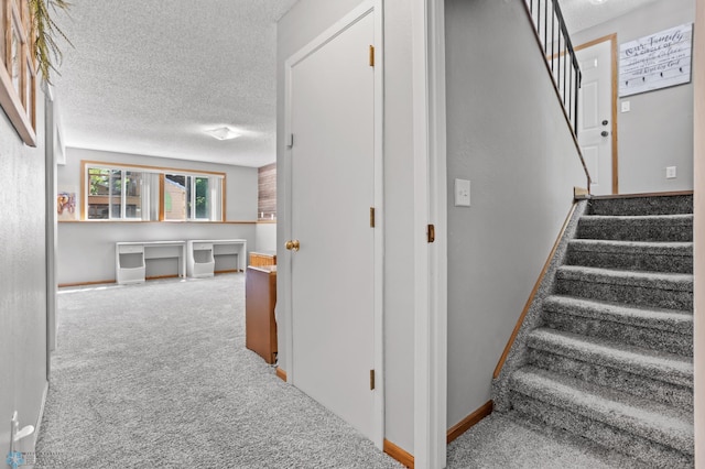 3003 15th Ave S, Moorhead, MN 56560 - stairway with a textured ceiling, carpet floors, and baseboards