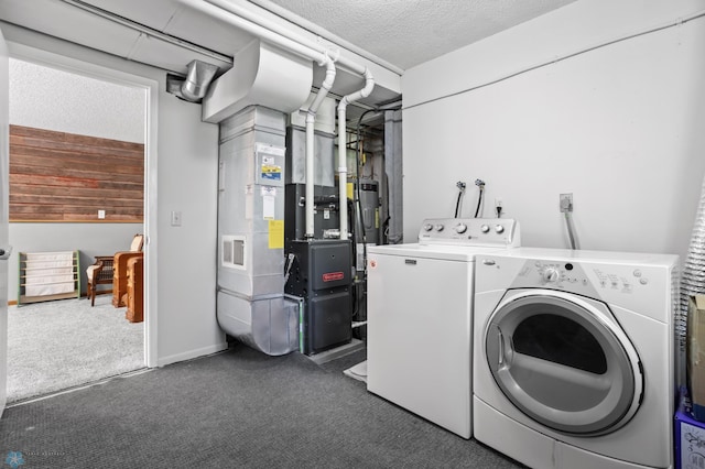 3003 15th Ave S, Moorhead, MN 56560 - laundry area featuring washing machine and dryer, carpet floors, a textured ceiling, and heating unit