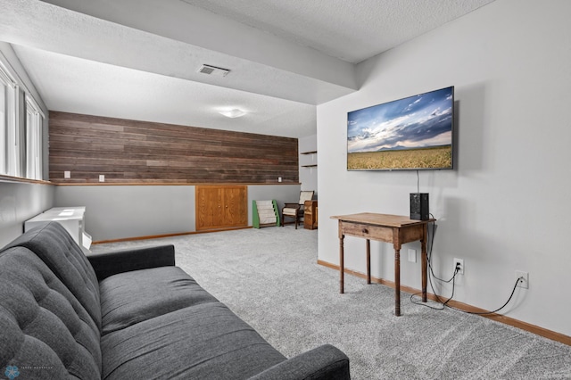 3003 15th Ave S, Moorhead, MN 56560 - carpeted living area with wood walls, a textured ceiling, and baseboards