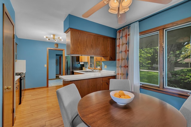 5843 Fairway Ln, Saint Cloud, MN 56303 - dining area with a ceiling fan, light wood-style flooring, and baseboards