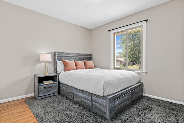 2613 107th Ln NW, Coon Rapids, MN 55433 - bedroom with baseboards and wood finished floors