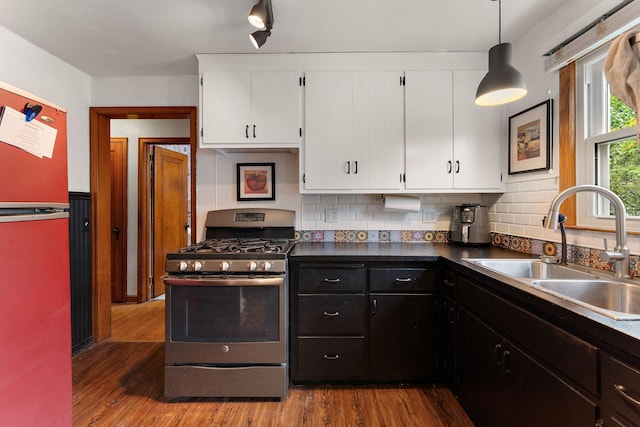 41 17th Ave N, Hopkins, MN 55343 - kitchen with stainless steel gas range, a sink, white cabinets, and wood finished floors