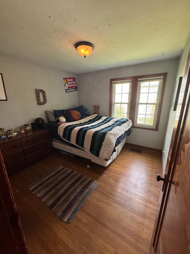 41 17th Ave N, Hopkins, MN 55343 - bedroom with wood finished floors and a textured ceiling