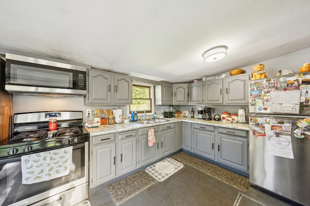 S233 Church Ave, Spring Valley, WI 54767 - kitchen with stainless steel appliances, gray cabinetry, a sink, and light countertops