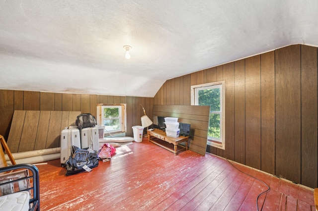 S233 Church Ave, Spring Valley, WI 54767 - bedroom featuring hardwood / wood-style flooring, lofted ceiling, and wood walls