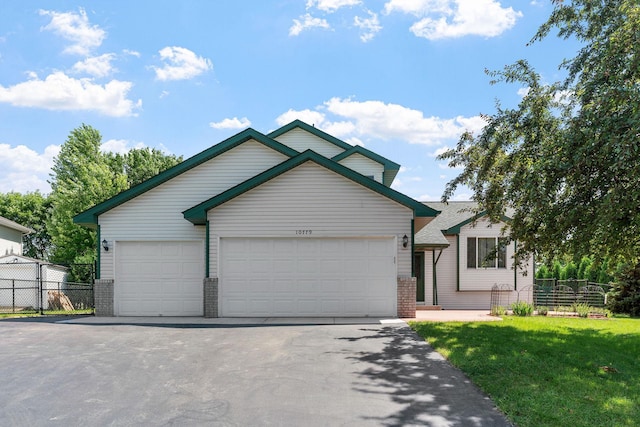 10779 57th St NE, Albertville, MN 55301 - view of front facade with brick siding, asphalt driveway, and an attached garage