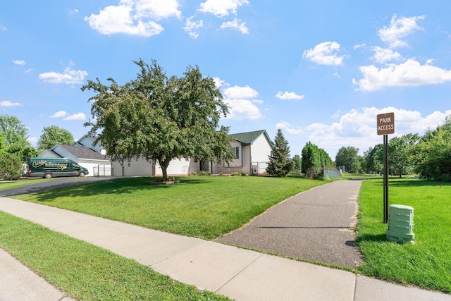 10779 57th St NE, Albertville, MN 55301 - obstructed view of property with a front yard, driveway, and a garage