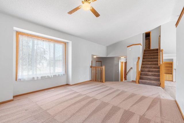 10779 57th St NE, Albertville, MN 55301 - unfurnished living room with ceiling fan, carpet flooring, and vaulted ceiling