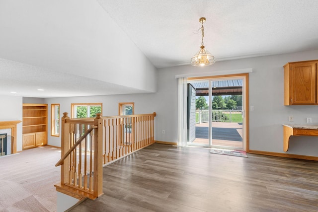 10779 57th St NE, Albertville, MN 55301 - interior space with a textured ceiling, wood finished floors, and a fireplace with flush hearth