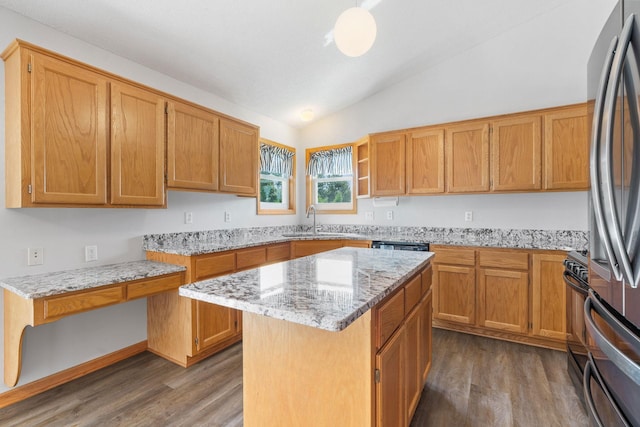 10779 57th St NE, Albertville, MN 55301 - kitchen with vaulted ceiling, dark wood-style flooring, stainless steel fridge, light stone countertops, and a kitchen island